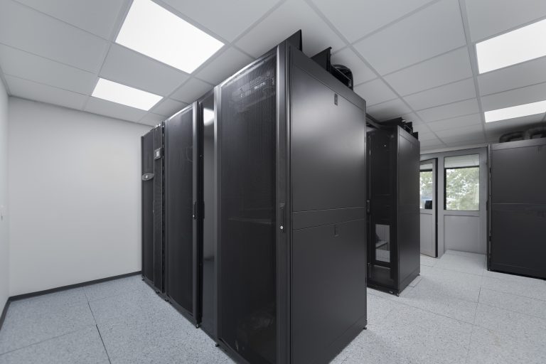 Data Center With Multiple Rows of Fully Operational Server Racks. Modern Telecommunications, Cloud Computing, Artificial Intelligence, Database, Supercomputer Technology Concept.